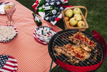 Camping enthusiast cooking on portable charcoal grill in outdoor setting